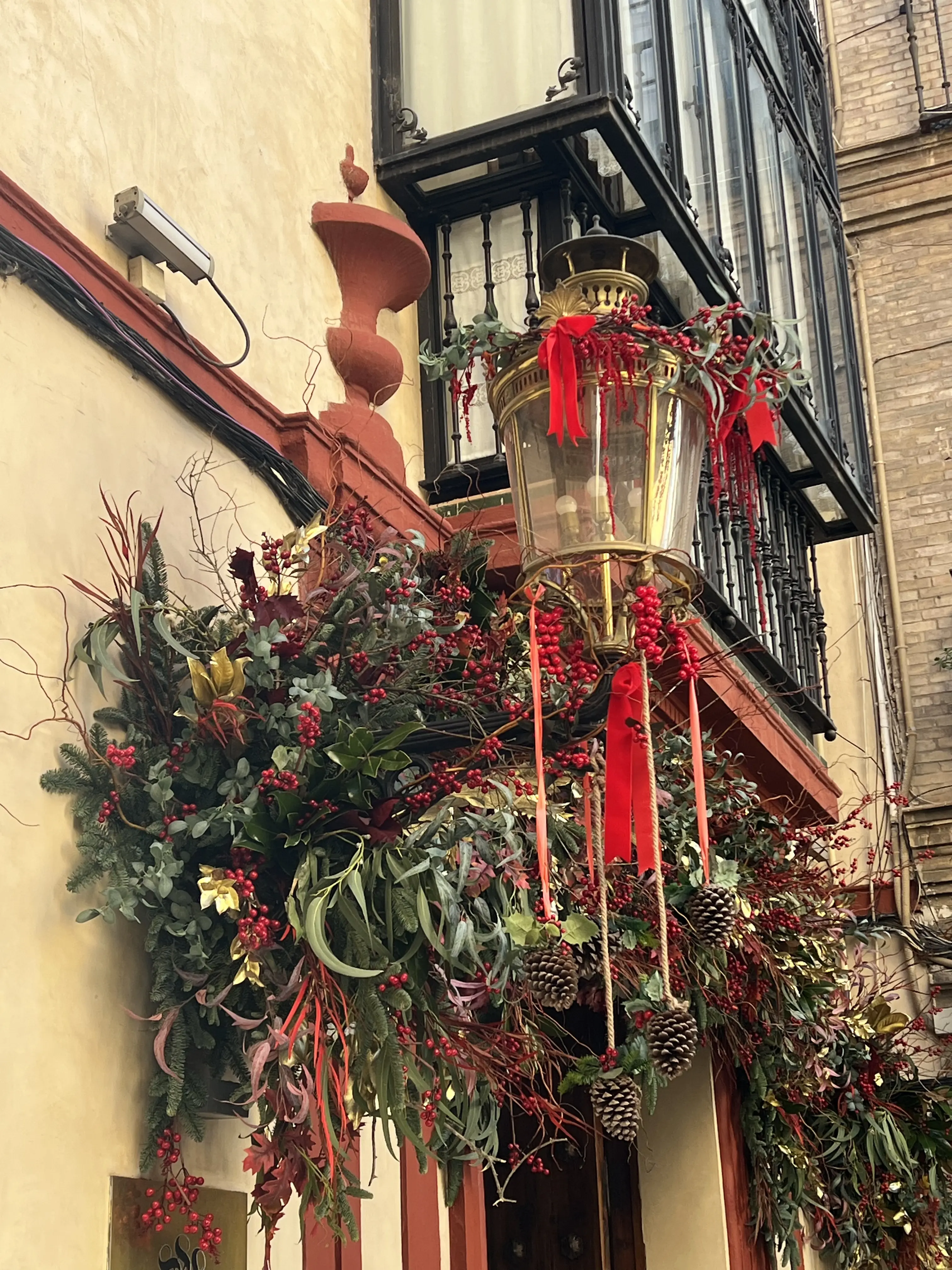 Vegetación decorativa con tonos rojos y dorados en fachada de hotel
